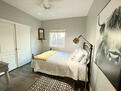 Bedroom with queen bed, desk, large closet