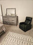 Lovely guest bedroom includes dresser, mirror