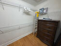 walk in closet with dresser and washer/dryer