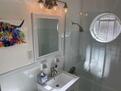 Shared bath w ceramic tub and glass enclosure