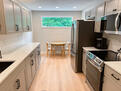 Kitchen has lots of natural light and a dinin