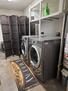 Private laundry room with utility storage