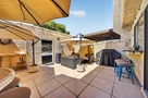 Fully furnished patio with gas grill and umbr