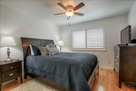 Master bedroom with fan and TV