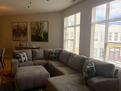 Light filled living room with sectional and 5