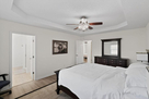 Walk-in closet and dresser in master bedroom.