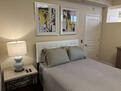 well lit bedroom with lamps and ceiling fan
