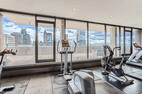 Cardio equipment overlooking the cityscape.
