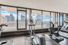 Cardio equipment overlooking the cityscape.
