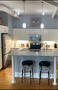 Kitchen with island, ceramic backsplash, unde