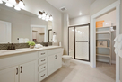 Master bathroom with double sinks and walk-in