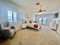 Primary bedroom, sitting area, & balcony