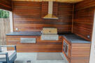 Sleek enclosed gas grill w/ built-in counter