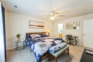 King  bed with connected bathroom with tub an