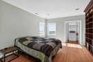 The upper level guest bedroom has a large wal