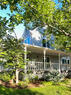 Front Exterior with mature trees and garden b