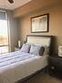 Carpeted bedroom with floor to ceiling window