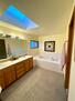 Master bathroom with tub and shower area