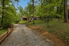 Generous driveway for vehicles and seclusion.