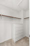 Primary bedroom walk-in closet and dresser