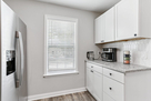 Kitchen view with refrigerator and coffee mak