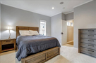 Main guest rooms with queen bed, side tables,