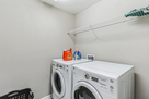 Laundry room with full size washer/dryer.