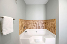 Spacious primary ensuite bathroom with tub an