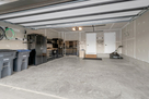 Garage space w/ storage cabinets and lawn car