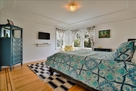 bedroom 3 with queen bed, closet, tv.