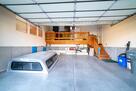 Garage with overhead storage & outside fridge