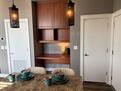 work space in kitchen with desk and cabinets