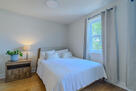 Bright queen bedroom with room to spread out