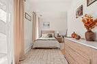 Bedroom with dresser and natural light