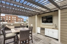 Rooftop dining area with kitchen and 60" flat