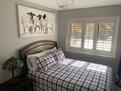Bedroom 2 w large window and artwork