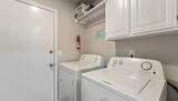 Laundry room off kitchen.  Opens into garage.
