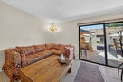 Kitchen has a comfortable couch, and opens to