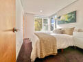 Primary bedroom with queen bed and designer l