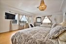 view of tv in king bedroom