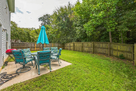 Large fenced yard with patio set.