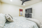 Guest bedroom with king bed and TV