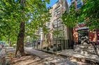 Tree-lined Newport Avenue and greystone exter