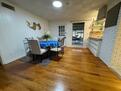 Dining room + screened in patio in background