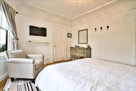 view of tv and chair in bedroom 1