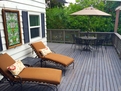 Chaise lounges, outdoor dining table and BBQ.