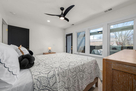 Bedroom 4: queen bed looking out to covered d