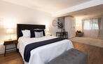 Downstairs bedroom with queen bed and full be
