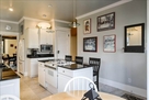 Full stocked kitchen with island and seating.