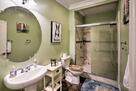 The first floor bathroom offers a walk-in sho